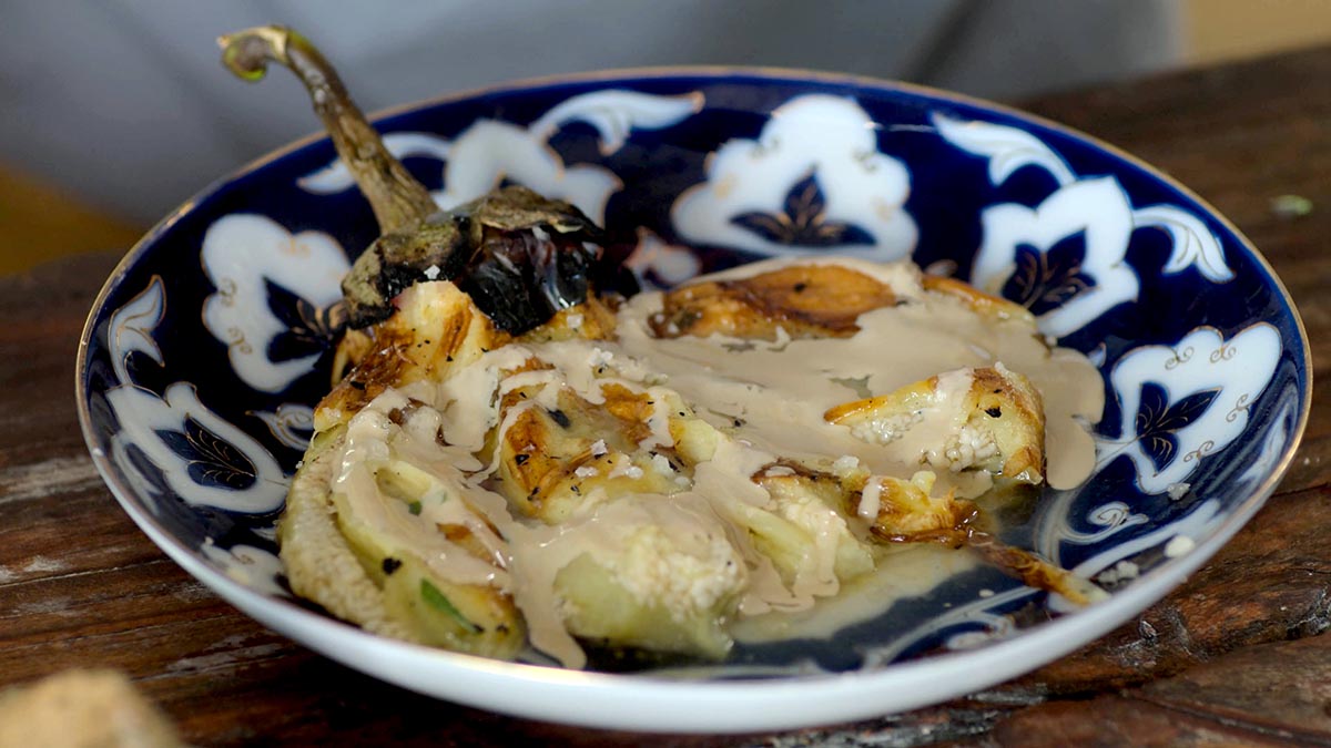 Fire-Roasted Eggplant Salad. The ultimate Israeli dish, char the eggplant directly in the fire and top with sweet and tart pomegranate syrup and rich tahini.