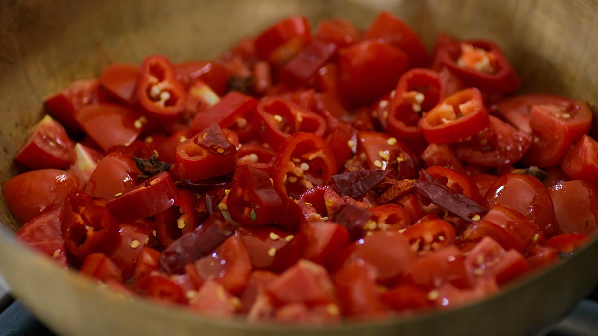 Matbucha. Make flaming hot Matbucha - a traditional Moroccan spicy tomato sauce full of chilis, ripe Roma tomatoes, garlic, and spices.