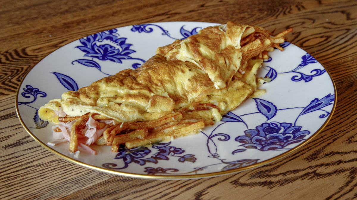 Revuelto Gramajo. “Eggs, potatoes, cheese, ham, can’t get better than that!” - Francis Mallmann. Revuelto gramajo is a Buenos Aires classic, most commonly found across the country in neighborhood bodegones (Argentine cantinas). Francis puts his own spin on this scrambler-hash hybrid that resembles an omelette, but stays true to its original ingredients: eggs, ham, and fried shoestring potatoes. This dish, however, can be adapted to use ingredients on hand, including fresh peas and slices of chicken or prosciutto. Even though in Argentina revuelto gramajo is eaten for lunch or dinner, we bet this mind-blowing dish will be a total brunch game-changer to your cooking repertoire.