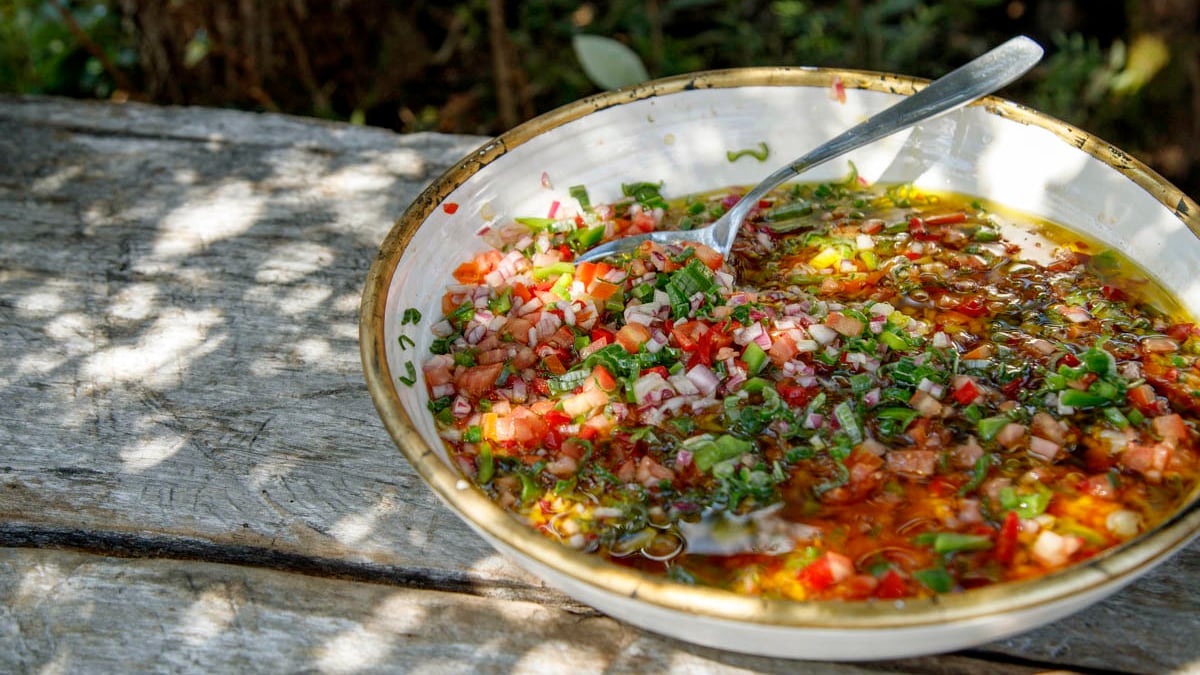 Salsa Criolla. No Sunday Asado in Argentina would be complete without salsa criolla, the national sauce, alongside chimichurri, that is served at traditional Argentine barbecues across the country. Francis’s version calls for a fresh medley of chopped onions, colorful bell peppers, tomatoes, red onions, and spring onions drenched in acidic red wine vinegar.