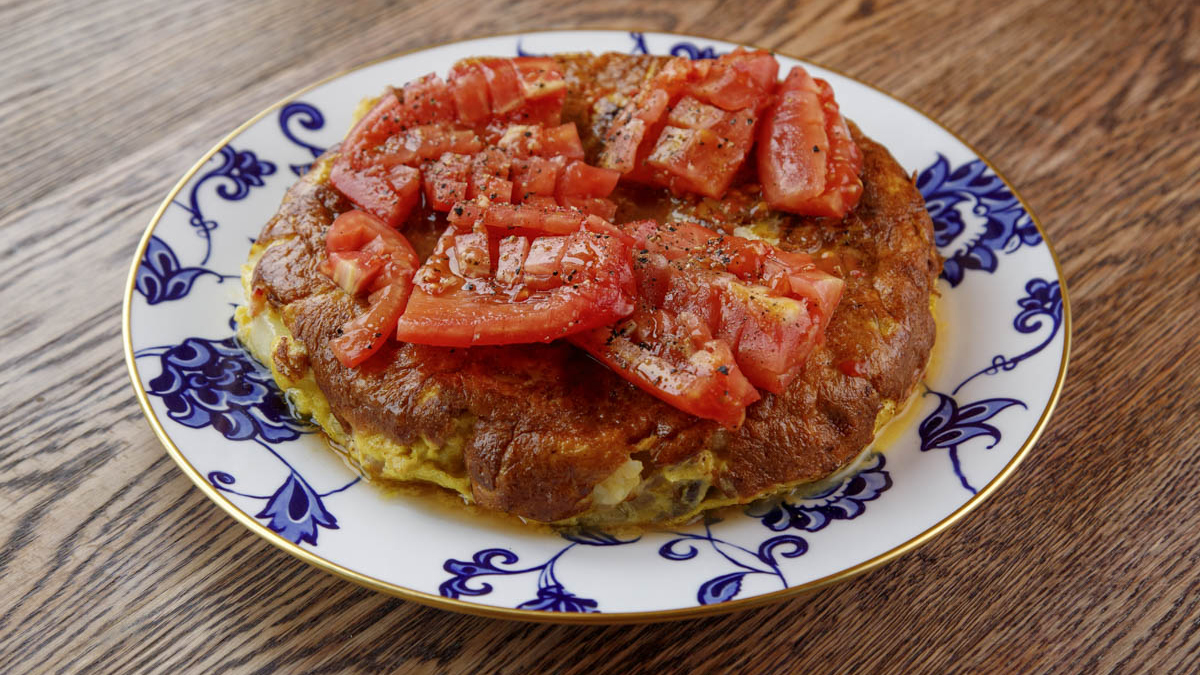 Tortilla. Argentina is heavily influenced by Spanish cuisine. It’s common to find the tortilla, a potato, onion, and egg Spanish omelette, at most every bodegón (Argentine cantina). Even though Francis has made many tortillas in his life, he says he only understood the true technique of the tortilla a few years ago when he observed a Spanish lady making it. Now, he shares this favorite tortilla recipe with you. While it’s possible to use any onions available, Francis’s secret is combining three types of onions. He also shares his tips on how to flip it and cook it to perfection.