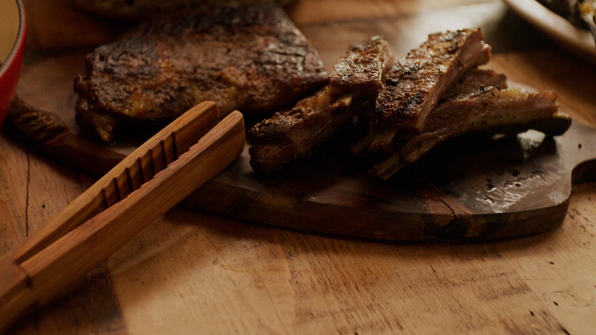 Spiced Lamb Riblets. We’re back in Nancy’s home kitchen where she’s preparing Spiced Lamb Ribs for a dinner party. Learn fun hacks like how to double wrap your meat in plastic and aluminum before it goes in the oven, and get a glimpse into Nancy’s quirky culinary world when she busts out a flea market coffee grinder to make her spice rub.